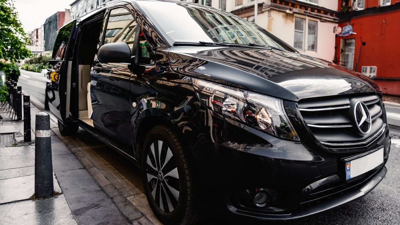 A black Mercedes V-Class with its sliding door open